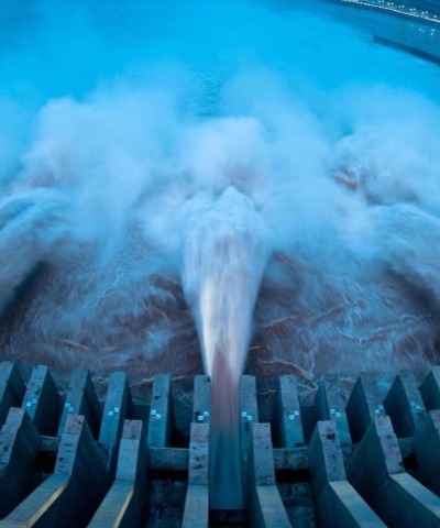 Hydropower station releasing water through turbines to produce clean renewable energy