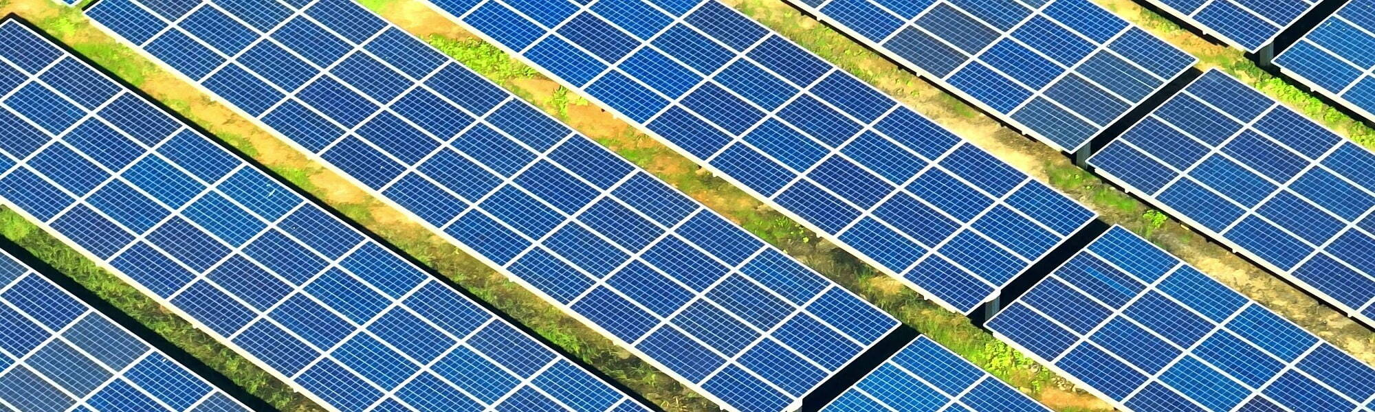 Solar photovoltaic panels generating renewable electricity at a ground-mounted solar farm