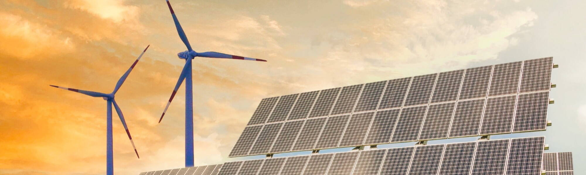 Wind turbines and solar panels generating renewable electricity at sunset, representing clean energy career opportunities